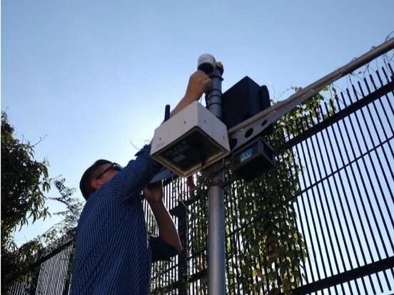 Dan Westervelt setting up a low-cost air quality monitor.