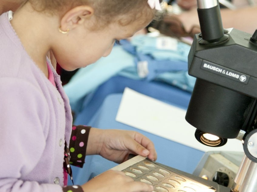 Lamont Open House Visitor Using a Microscope