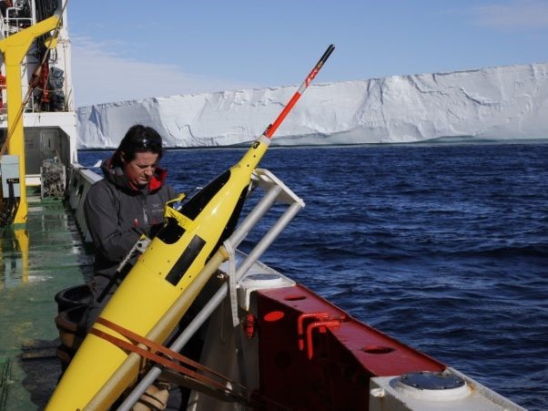 Pierre Dutrieux preparing a Seaglider for deployment in front of the Dotson Ice Shelf, West Antarctica, during a summer 2018 research expedition. (Photo courtesy of Pierre Dutrieux)