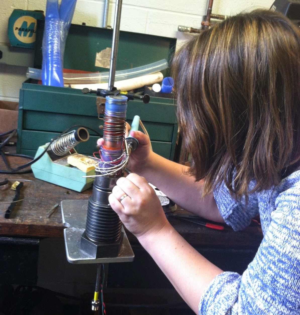 Postdoc Sarah Lambart solders wires for a triax experiment (2014)