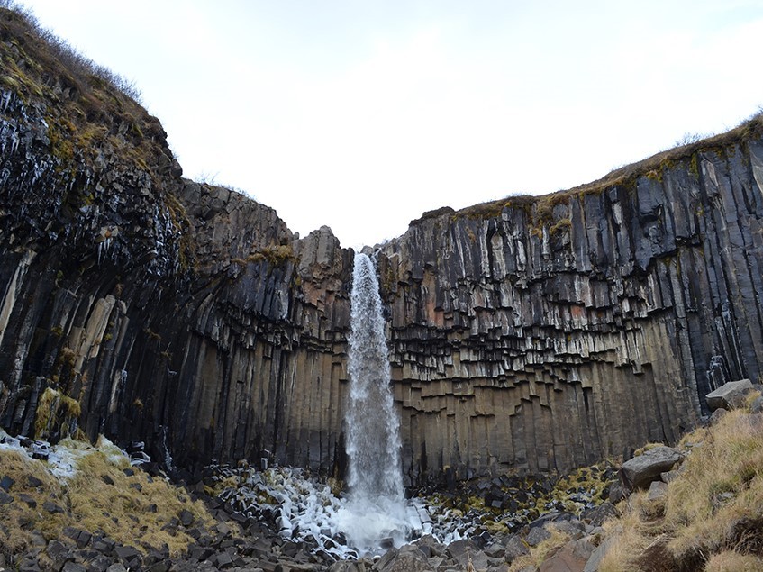 The secret to permanently storing carbon underground is basalt, the volcanic rock that underlies 90 percent of Iceland. Near the southern coast, the landmark Black Falls plunges over a precipice of pure basalt columns. Credit: Kevin Krajick/Earth Institute