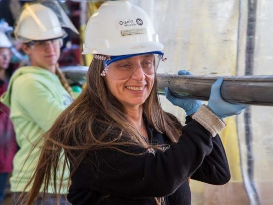 Gisela Winckler carrying a sediment core during IODP Expedition 383. Credit: Tim Fulton & IODP