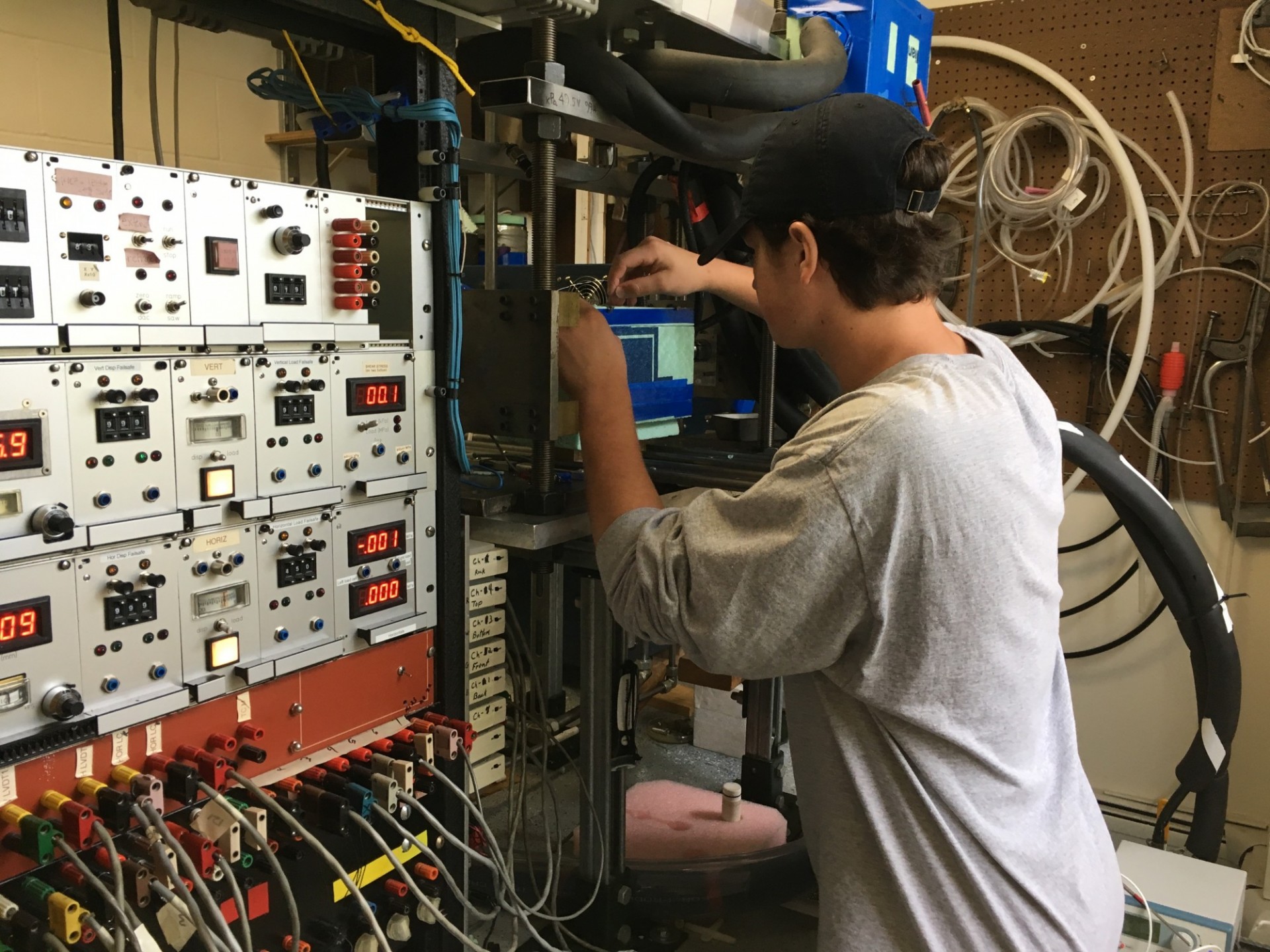 High school intern Will Kerin works on the set up for pressure film experiments to measure contact growth in ice (2019).