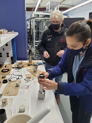 Lamont Rock Mechanics Lab Postdoc Catalina prepares a sample for carbon mineralization while Ted looks on. Credit: Jacob Tielke