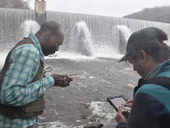 Structural geologist Folarin Kolawole and postdoc Zachary Foster-Baril of Lamont-Doherty Earth Observatory prepare to analyze a rock outcrop next to the Lake Solitude Dam in High Bridge, NJ near the epicenter of the magnitude-4.8 earthquake that took place the previous week on April 5, 2024. Credit: Kevin Krajick