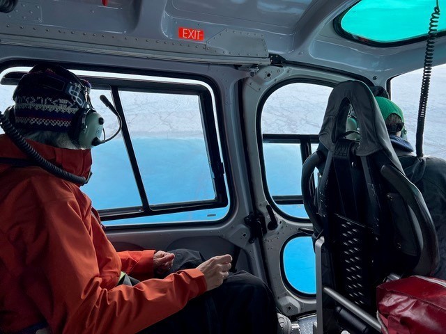 Columbia University researcher Meredith Nettles (left) and Laura Stevens of Oxford University approach a Greenland supraglacial lake via helicopter. Credit: Marianne Okal, UNAVCO