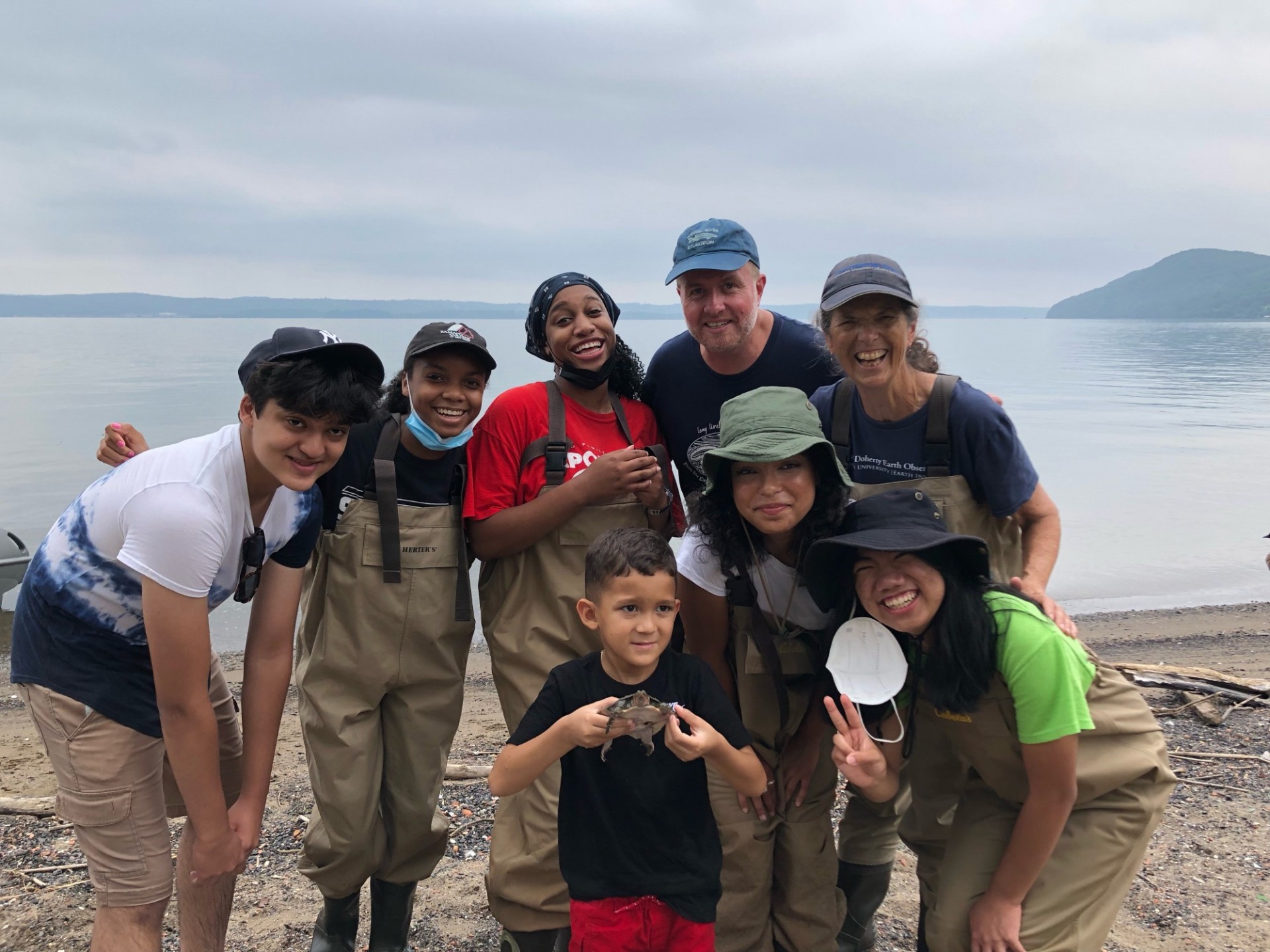 Next Generation of Hudson River Educators 2021 with community member Moses Jr. (center) holding a softshell turtle that the group named Moses III in his honor. Credit: Moses Sr.