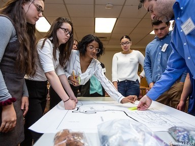 At the symposium, students work with community mentor County Legislator Alden Wolfe in their revisioning of a local site. Planning Activity