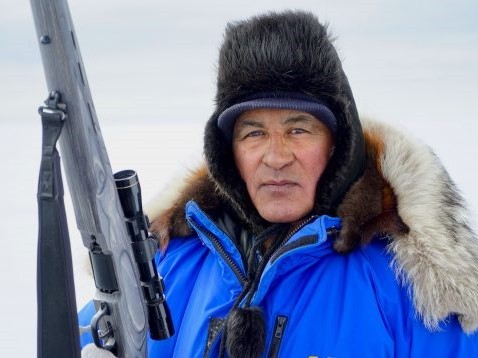 Roswell Schaeffer Sr., an Iñupiaq elder and hunter from Kotzebue and coauthor of a recent study of ice-season changes, hunts for bearded seals, May 2019. Credit: Sarah Betcher, Farthest North Films