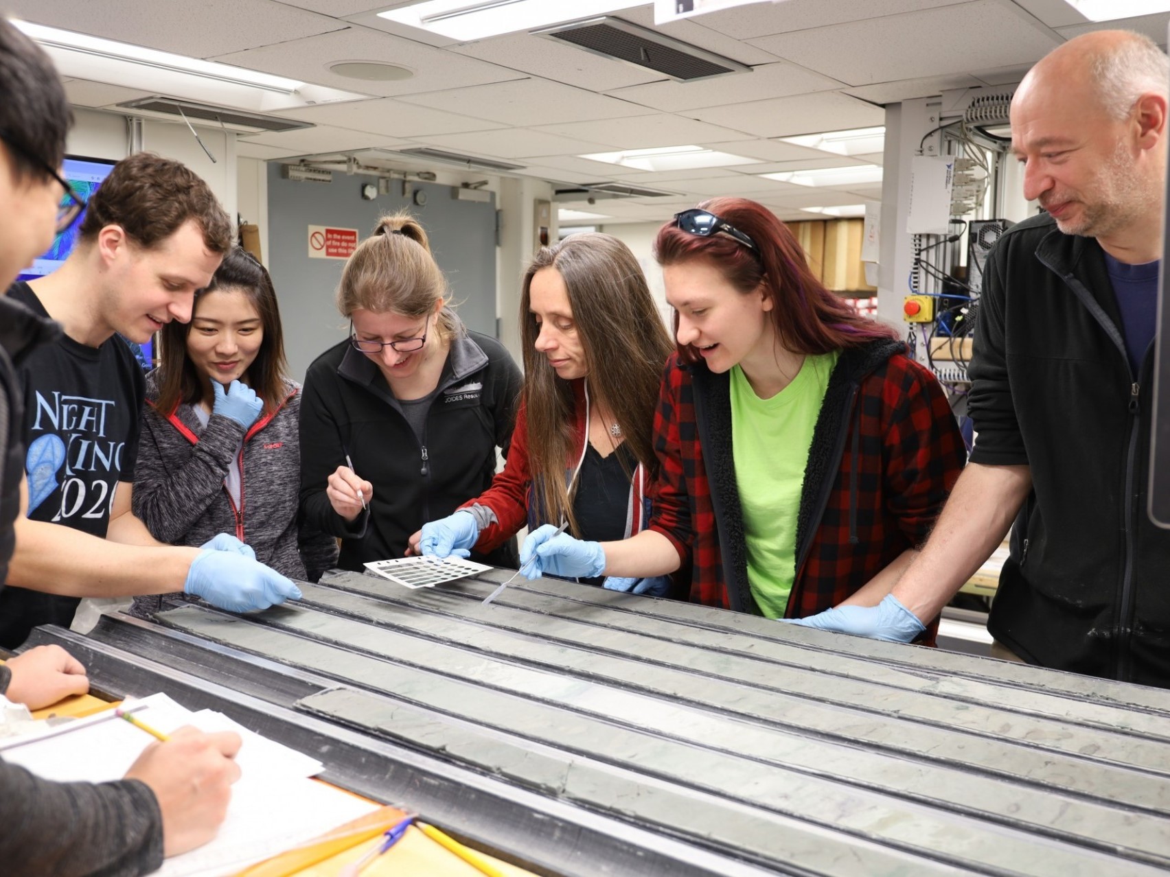 WINGS Lab at Lamont - Members of Expedition 383 Examine a Freshly Split Sediment Core