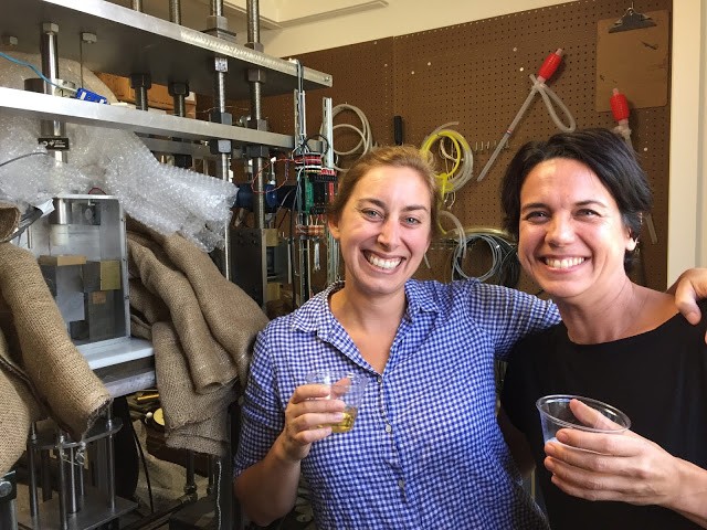 Heather Savage and Christine McCarthy share Champagne to celebrate ice sliding on rock for the first time ever in our lab (2015).