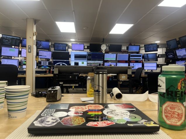 View of all the monitors in the main lab from the desk I have set up my personal workstation on. Slip-resistant liner is used to keep our laptops and other precious objects from taking flight as the ship rocks back and forth.