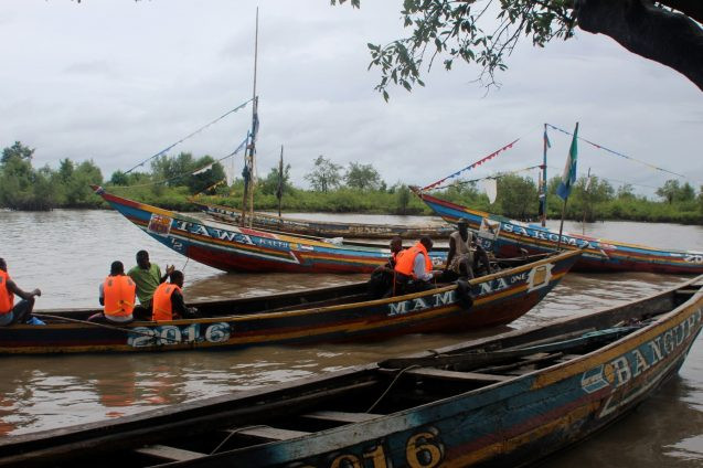 people wearing life vests in a small boat