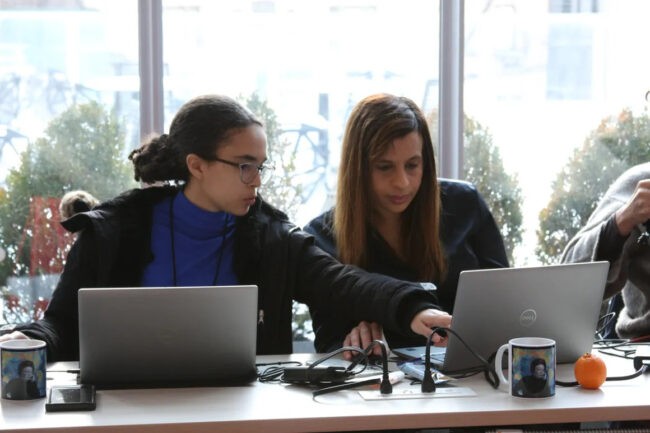 Two Girl Talk workshop participants working on laptops