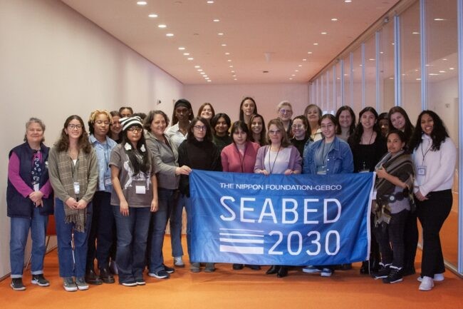 Girl Talk workshop participants and leaders posing with Seabed 2030 flag.