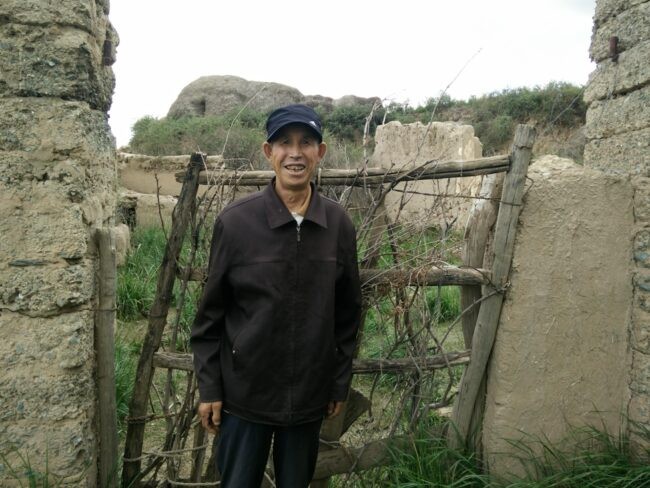 Man visiting former home in hill country of Gansu Province, China (Alex de Sherbinin, CIESIN)
