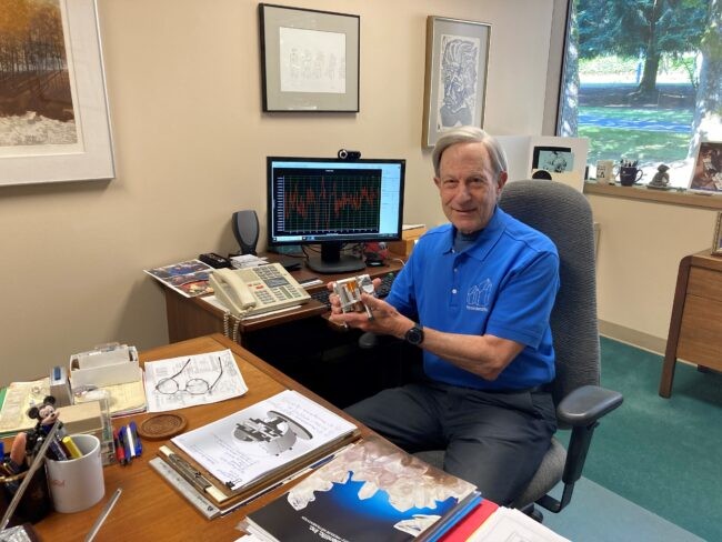 Inventor and philanthropist Jerry Paros, pictured in his office holding a Paroscientific's first Seismic + Oceanic Sensors (SOS) circa 2015. 