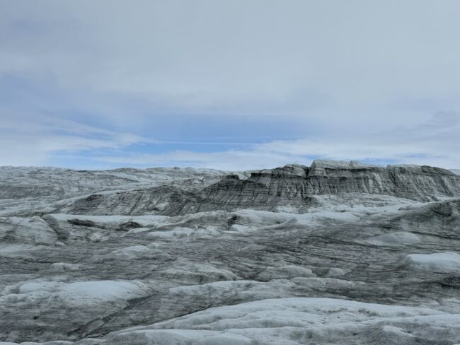 Ice covered by metamorphosed snow (dark in the infrared and invisible to our eyes) and light-absorbing material (soot, dust, algae, etc.)