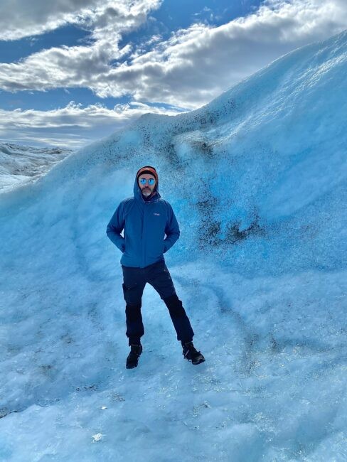 Marine and polar geophysicist Marco Tedesco standing on a field of ice