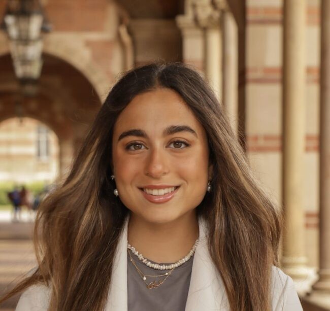Woman smiles in white jacket