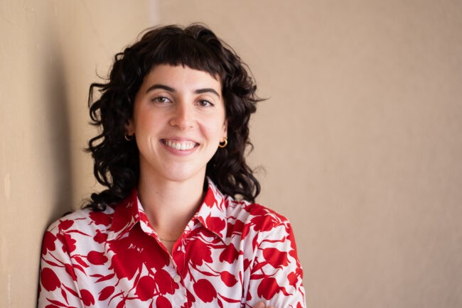 Headshot of woman in red and white top