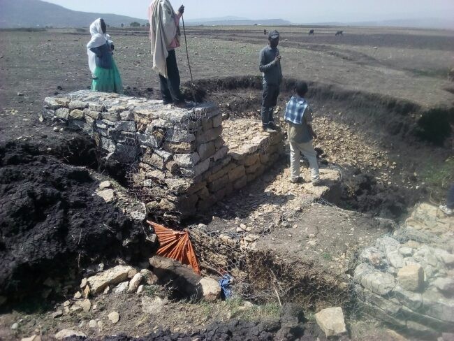workers building a dam in dry area