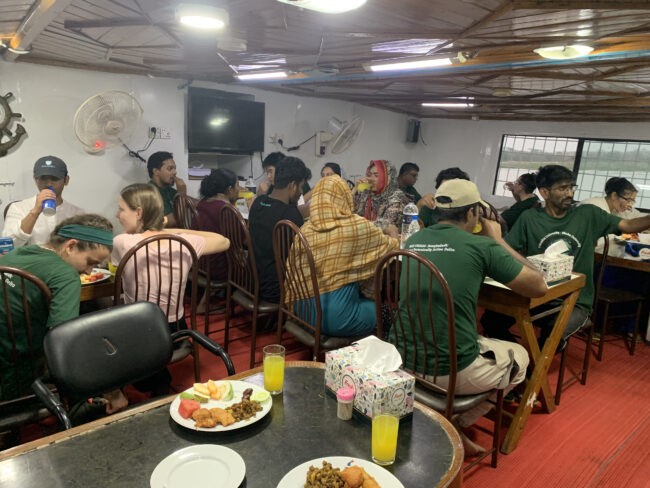 Group enjoys a meal on a ship