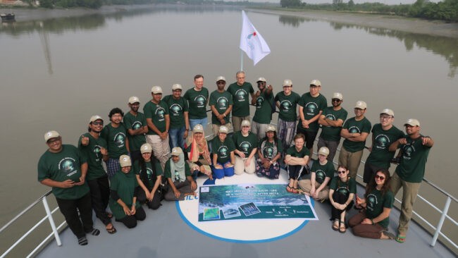 Group in matching shirts aboard a ship
