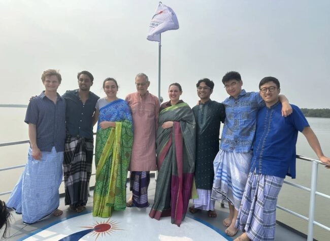 Students on ship in Bangladesh dressed in traditional clothing