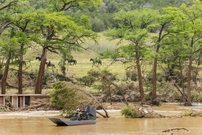 An image of a large, muddy river and flood damage in Kerrville, Texas