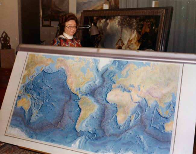 Geologist Marie Tharp holds the world ocean floor map