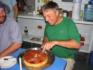 Steve cutting his flan birthday cake