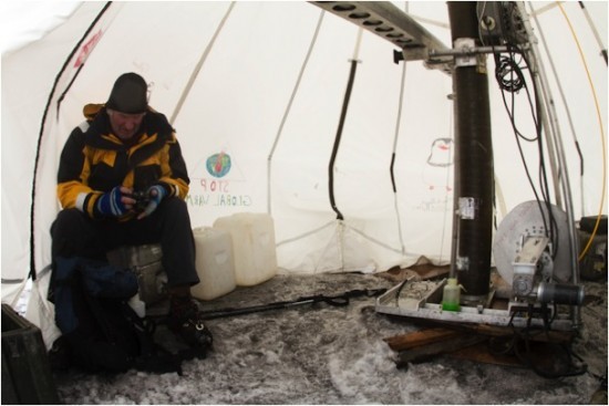 The drill, powered by a generator, contains a hollow-bit tip. This is followed by sections of pipe that allow us to pull up cores of ice as the bit penetrates—much like drilling an oil well (but without the same problems). On left: Team member geos