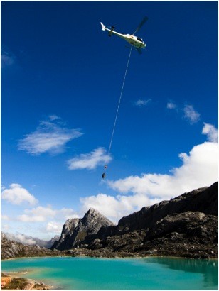 The helicopter passes base camp, well below the summit, on its way down