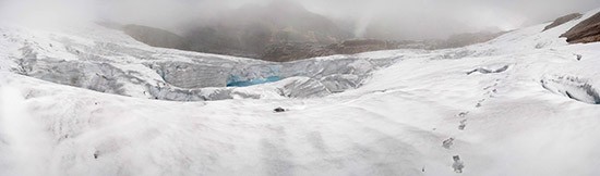 This meltwater lake has formed on the surface of the glacier—a possible portent of quickening destruction. For one thing, liquid water tends to absorb more heat than does snow or ice, which reflect energy. Once a pond forms, it can become a hot spo