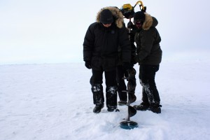 Andy, Kyle and Craig prepare to finish drilling a hole in the ice.