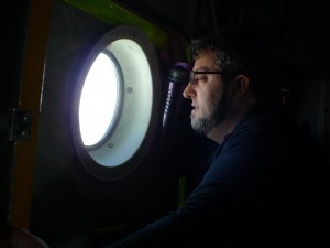 Chris Zappa,oceanographer and project optics expert, peers out the window of the LC130 aircraft.