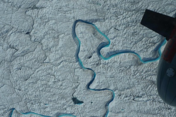 The tip of the icepod can be seen as we move over this meandering meltwater channel on the icesheet. (Photo M. Turrin)