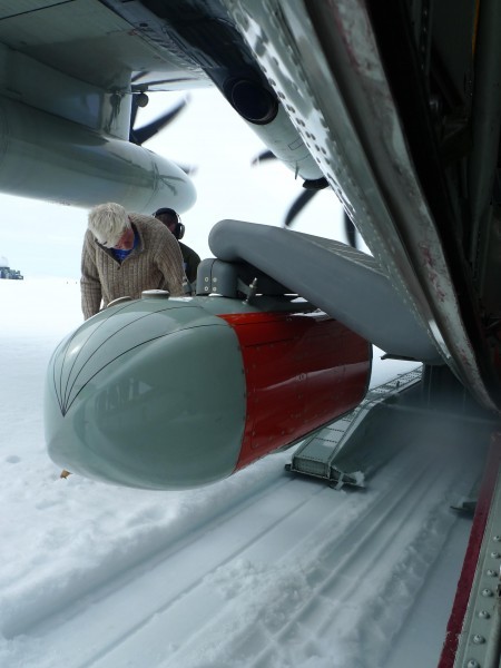 Nick Frearson, lead engineer on the Icepod project prepares to check the pod for snow after the ice runway landing at Raven Camp. (Photo M. Turrin)