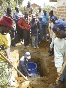 Jim Gaherty installs a seismic station in Masoko as a crowd looks on