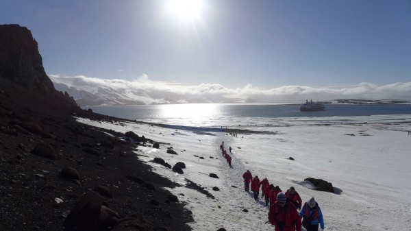 A group from the delegation climbs up the side of Deception Island to look through Neptune's Window at the Antarctic peninsula. (Photo M. Turrin) 