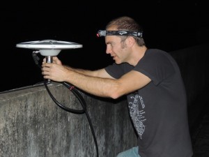 Scott adjusting the GPS antenna at the new Khulna site, working into the night.