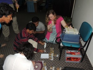 A group of students measure magnetic susceptibility of well samples that were collected the day before. The measurements help distinguish whether the sediments were deposited by the Brahmaputra or other rivers. 