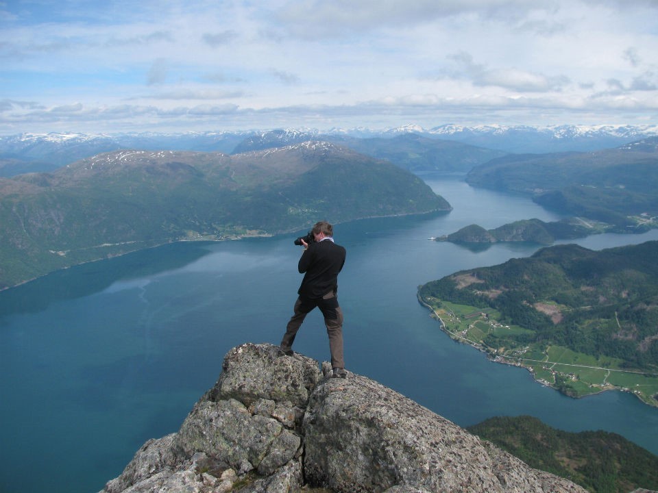 Hyenestøya, the easternmost peak in the Hornelen basin, sits high above the blue depths of Nordfjord. The team summitted this peak to collect a sample and take photos of Jostedalsbreen, Europeâs largest glacier, visible on the skyline. (Temp Norway 9