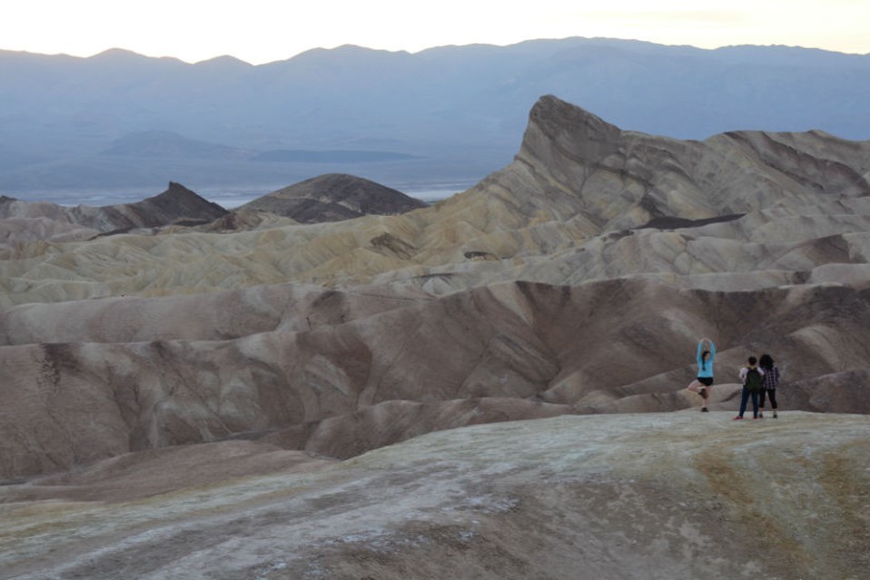 Death Valley is among the youngest and most volcanically active parts of the Basin and Range. At Zabriskie Point, minerals from hot springs give the silty sediments rose and mustard-colored hues. The rain-sculpted badlands are the remnants of an anci DV9