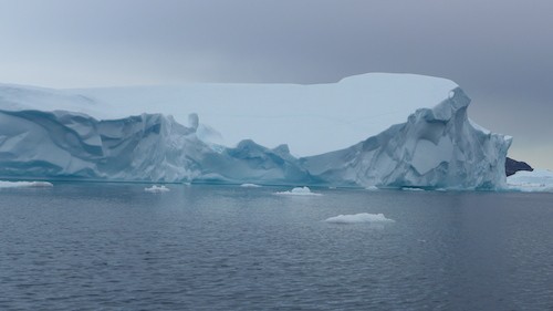 The local community talked of the distinction between large and small icebergs. Minitoq,the large iceberg, were described as being more tabular in shape, very high and straight sided, extremely large and more dangerous when they split or broke apart because of the large waves they could generate or the sudden ice fall that could bury a boat. The iceberg pictured here was not a minitoq but was large enough to be skirted with a respectful distance in the boat.
