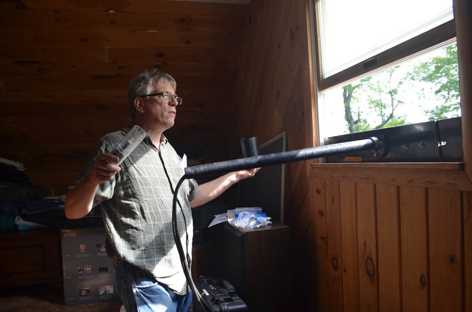 Lamont geochemist James Ross assembles an air sampler in an upstairs window of Beckâs house. It will take background readings for a couple of weeks, before drilling starts. 12