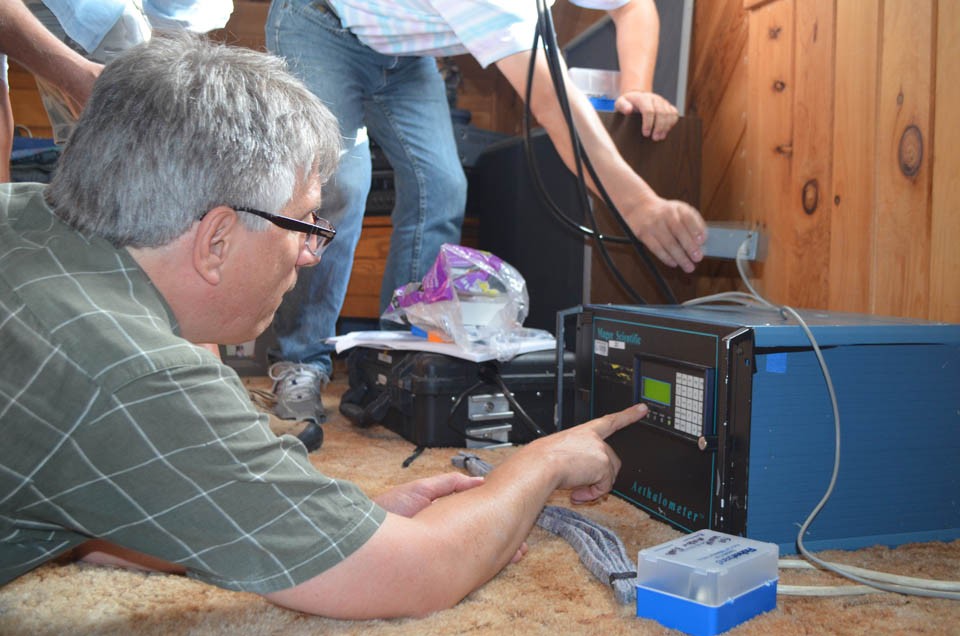 The equipment will take a reading every five minutes for two weeks. Ross makes some final settings. 14