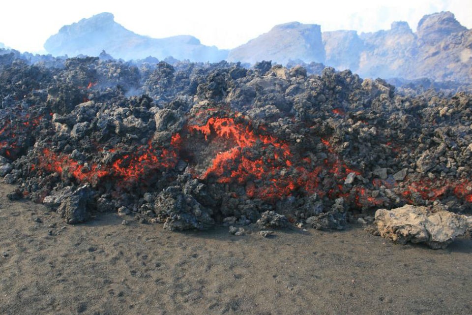 Fast-moving lava with rough surfaces, or aâa lava, oozed down the crater, rapidly covering the caldera floor. advancing lava 960