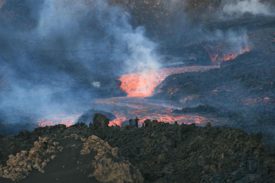 Geologists approached the lower vent to watch close up the river of lava streaming out. lava flow 960